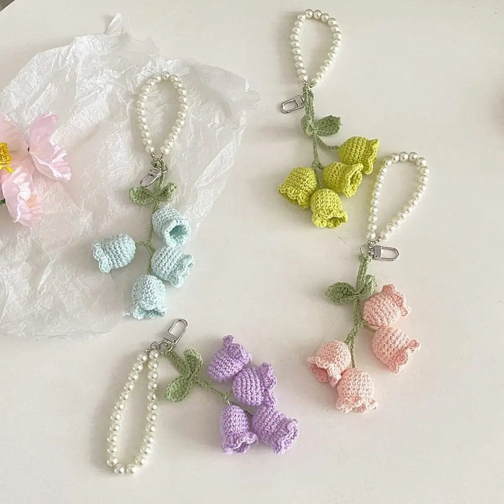 Handmade pearl chain orchid key rings in pastel shades of green, blue, and pink.