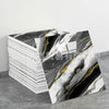 Stack of faux marble 3D self-adhesive wall tiles featuring black and white marble patterns with gold veining
