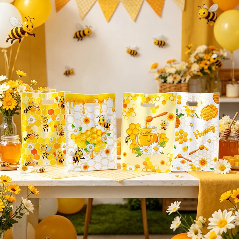 Yellow and white bee honey gift bags with handles for party favors displayed on a table.