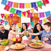Colorful papel picado banners strung across a festive setting for celebrations