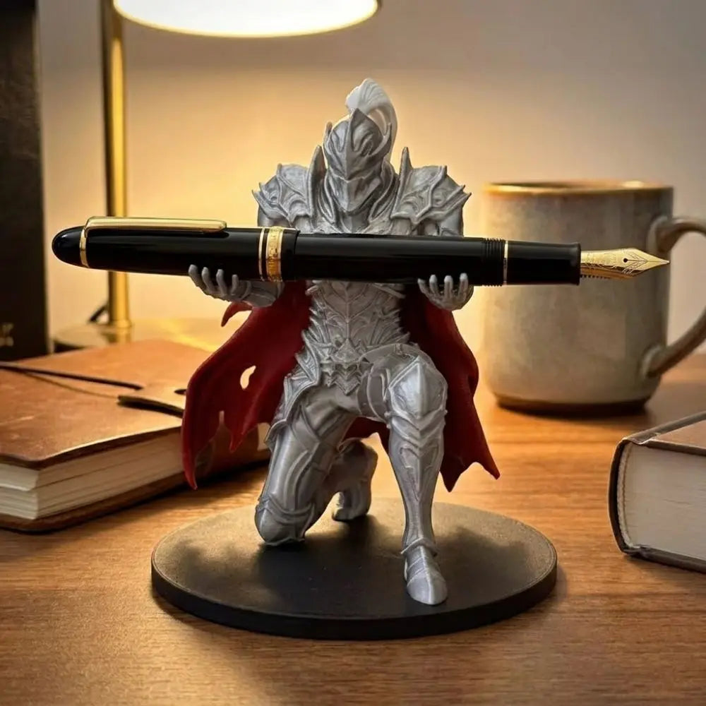 A 3D printed silver knight figure holding a black pen, serving as a unique desk organizer.