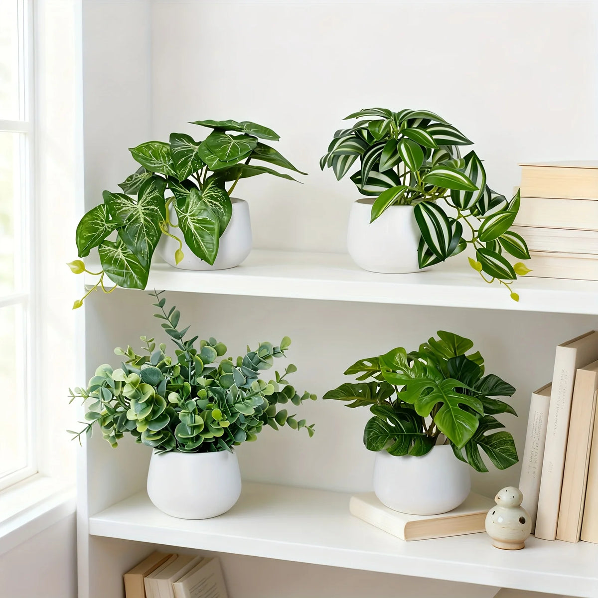 A collection of artificial bonsai succulent plants in white pots displayed on a white shelf.