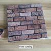 A rectangular pattern of textured brown and reddish-brown brick wall stickers on a wooden surface.