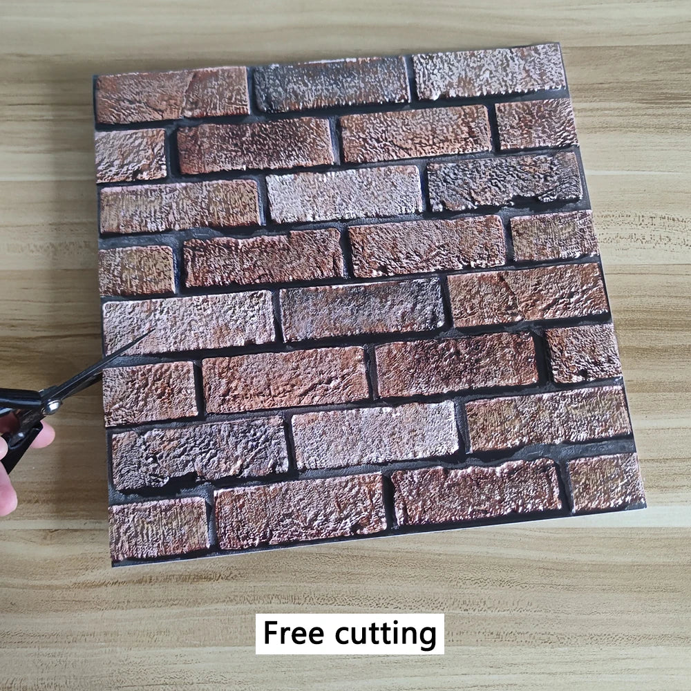 A rectangular pattern of textured brown and reddish-brown brick wall stickers on a wooden surface.