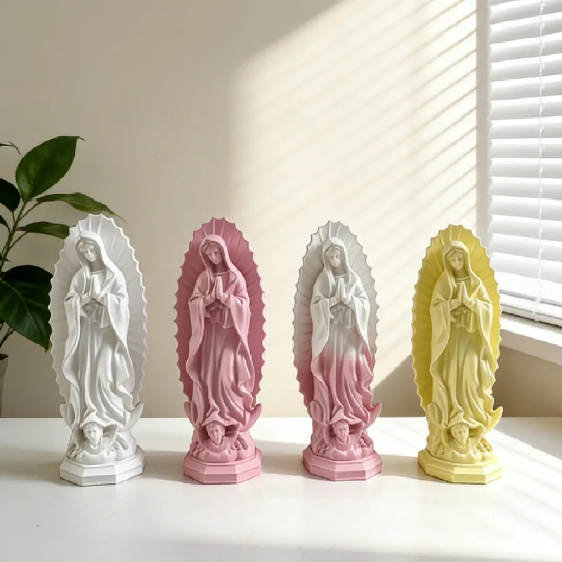 A set of four resin statues depicting Our Lady of Guadalupe in white, pink, mauve, and yellow.