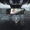 Silver cross pendant depicting open prayer hands hanging from a rearview mirror.