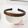 A brown braided hair band is shown resting on a white ceramic mug.