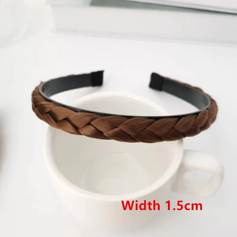 A brown braided hair band is shown resting on a white ceramic mug.