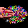 A hand holds a pile of colorful crystal ice cube acrylic stones for decoration against a black background.