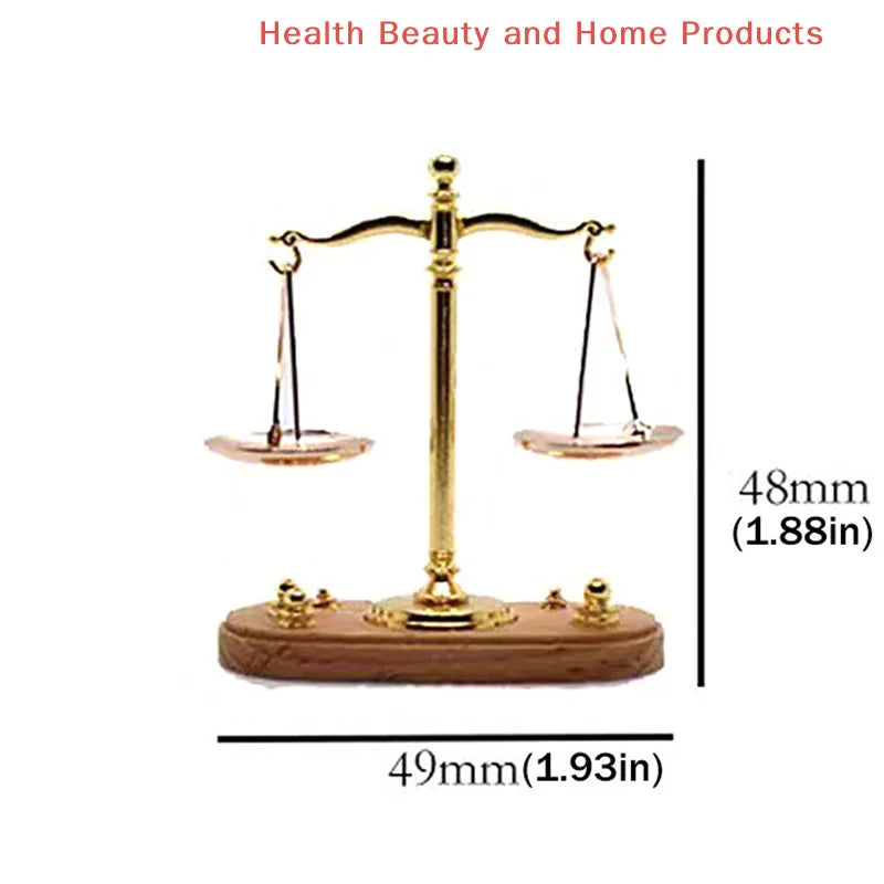 A vintage miniature balance scale with a brass column and wooden base used for decor.
