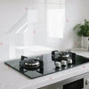 A transparent film protecting a black stovetop surface on a kitchen counter.