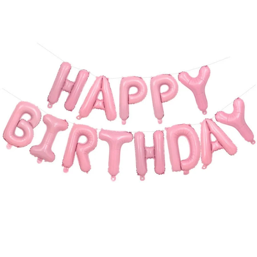 A string of pink letter foil balloons spelling out Happy Birthday for party decoration.