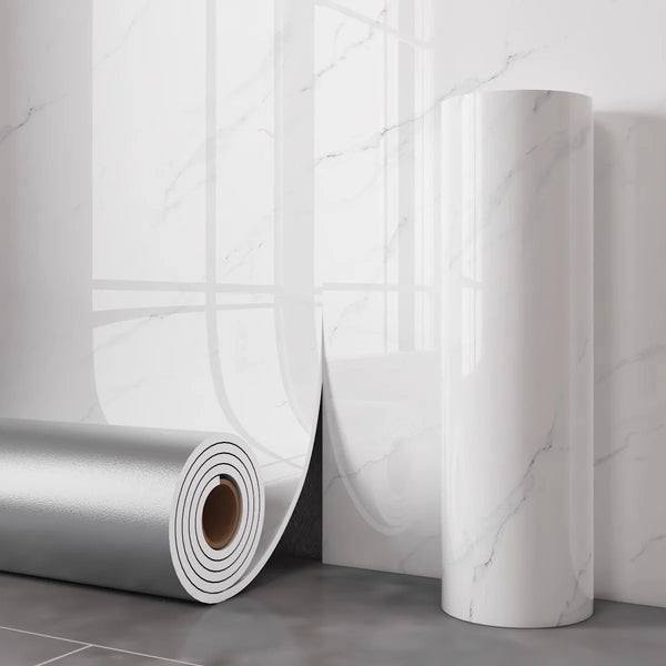 A roll of white faux marble wall decals or self-adhesive tile displayed next to a white wall with marble patterns.