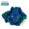 A blue textured figurine of a cat head with large ears, made from silicone or similar material.