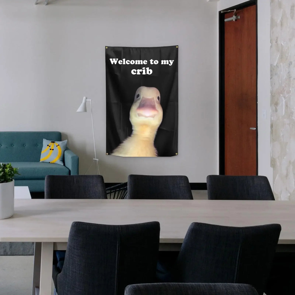 A black flag with white text welcoming to a crib featuring a yellow animal face.