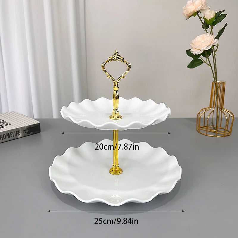 A set of gold-edged white decorative food trays for serving, displayed on a gray surface.