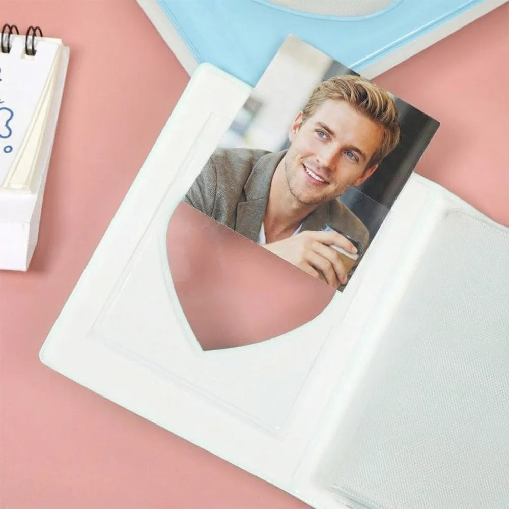 A man is featured in a photo album with a heart-shaped cutout, resting on a pink surface.