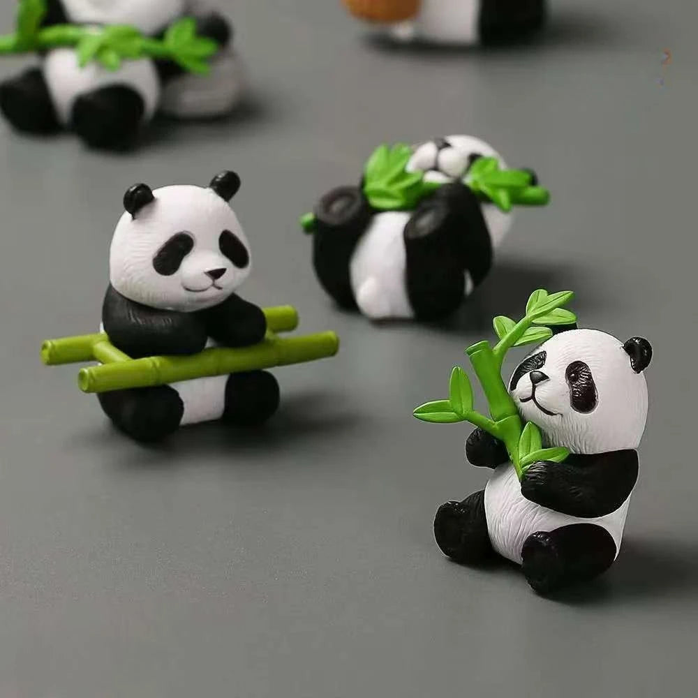 A set of mini resin panda bonsai figurines with green leaves and branches on a gray background.