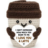 Handwoven knitted coffee cup cozy with a smiling doll decoration in brown and beige tones