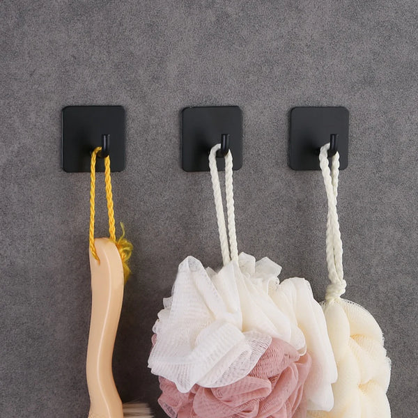 Three black stainless steel self-adhesive wall hooks with yellow and white cord hangers against a gray background