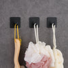 Three black stainless steel self-adhesive wall hooks with yellow and white cord hangers against a gray background
