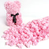 A pink artificial rose bouquet and loose rose petals for DIY decoration.