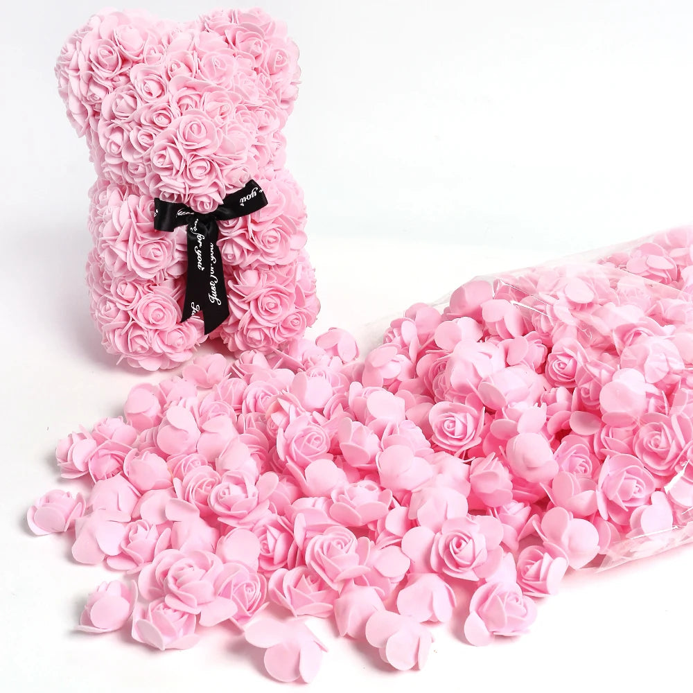 A pink artificial rose bouquet and loose rose petals for DIY decoration.
