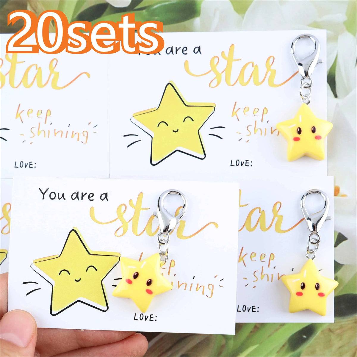 A set of 20 inspirational star keychains featuring yellow stars with smiling faces and gold accents.