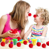 A child and an adult are playing with red foam balls, likely for costume noses or party props.