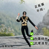 A black action figure of Michael Jackson with a poseable wire skeleton, shown in a full-body shot against a natural outdoor b