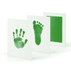 A set of white ink pads featuring green handprint and footprint designs.