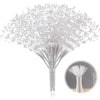 A close-up view of a delicate, white pearl string bead tree with fine strands branching out.