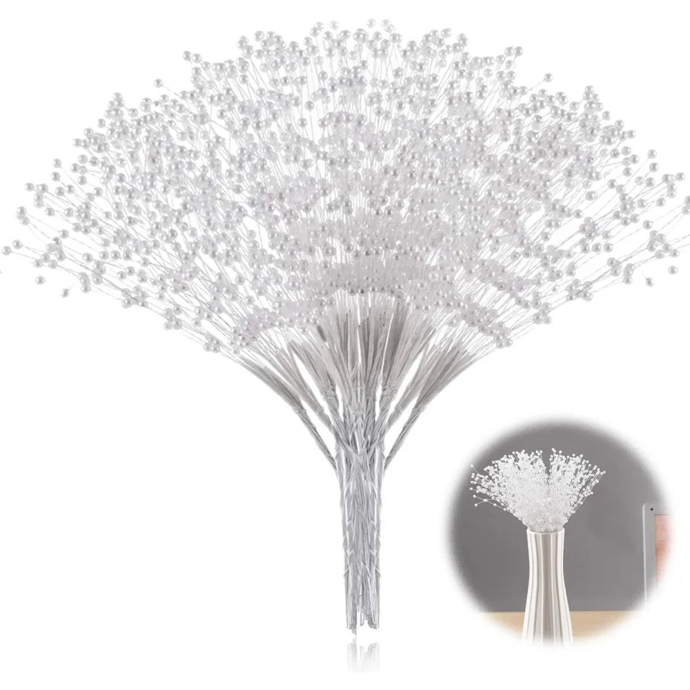 A close-up view of a delicate, white pearl string bead tree with fine strands branching out.