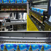 Printing machines inside a factory room with various printing setups for wall art.