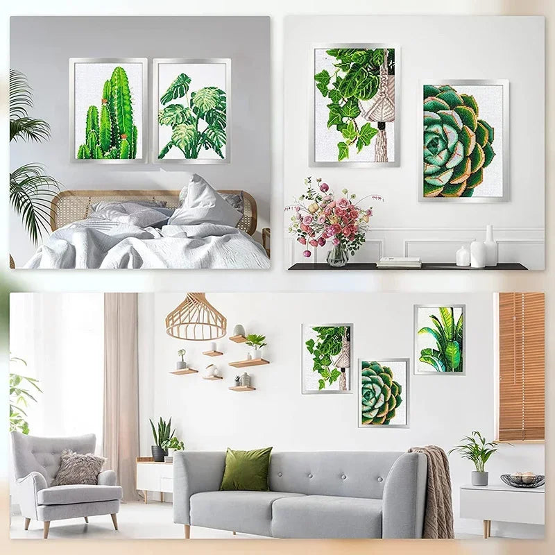 A display of framed diamond art and photos on a white wall, featuring green foliage and natural elements.