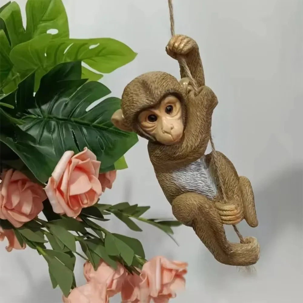 Handmade resin climbing monkey figurine with green leaves and pink roses for patio decor