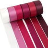 A set of satin silk ribbons in various shades of pink and burgundy rolled together for crafting