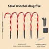 Five red and white candy cane shaped solar lights are shown, demonstrating waterproof performance for indoor and outdoor use.