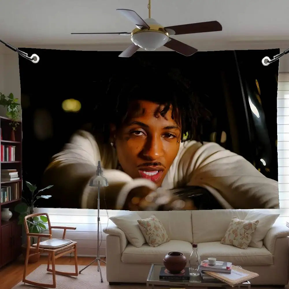 A person with dreadlocks is looking directly at the camera indoors.