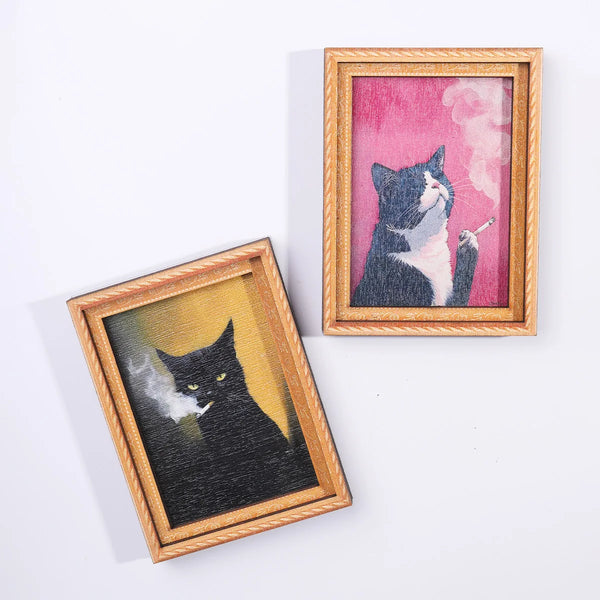 A framed artwork featuring a black cat smoking, displayed in a wooden frame.