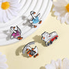 A set of enamel pins featuring cartoon geese and flower designs on a light background.