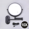 A round, illuminated magnifying makeup mirror with a black mounting bracket and USB charging cable.