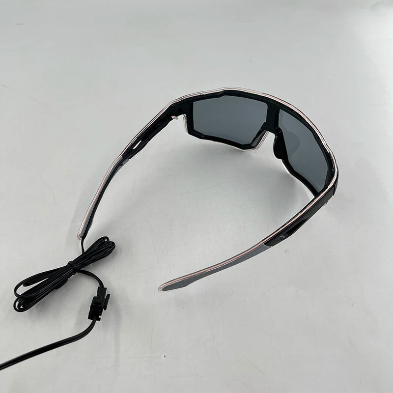 A pair of black wire-frame party glasses with dark lenses and an attached cord.