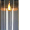 A tall, cylindrical glass candle holder with a glowing flame inside.