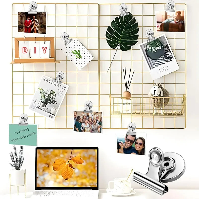 A collection of heavy duty fridge magnetic clips displayed on a gold grid background.
