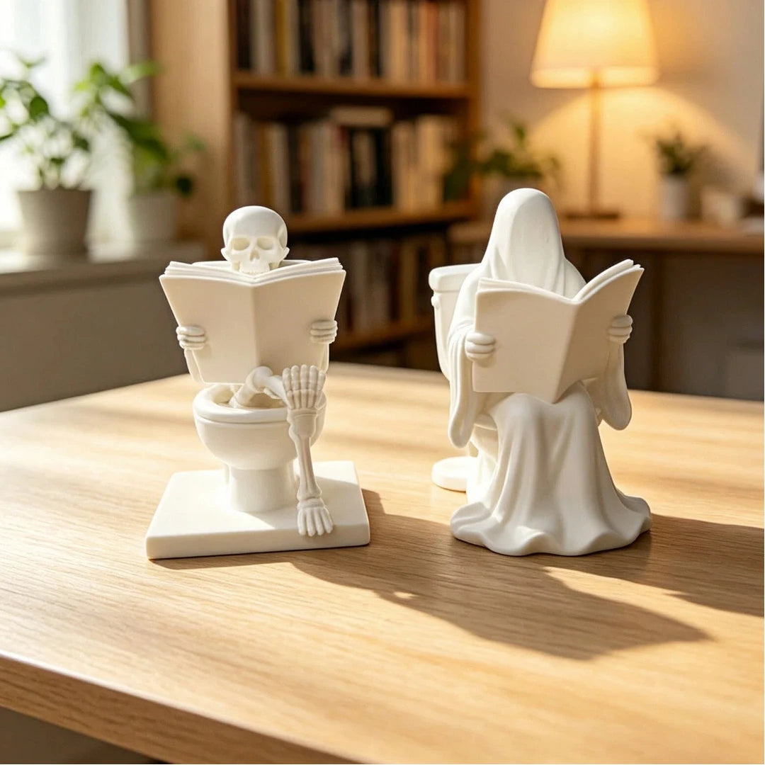 White ceramic statue depicting a skeleton ghost reading a book on a toilet bowl