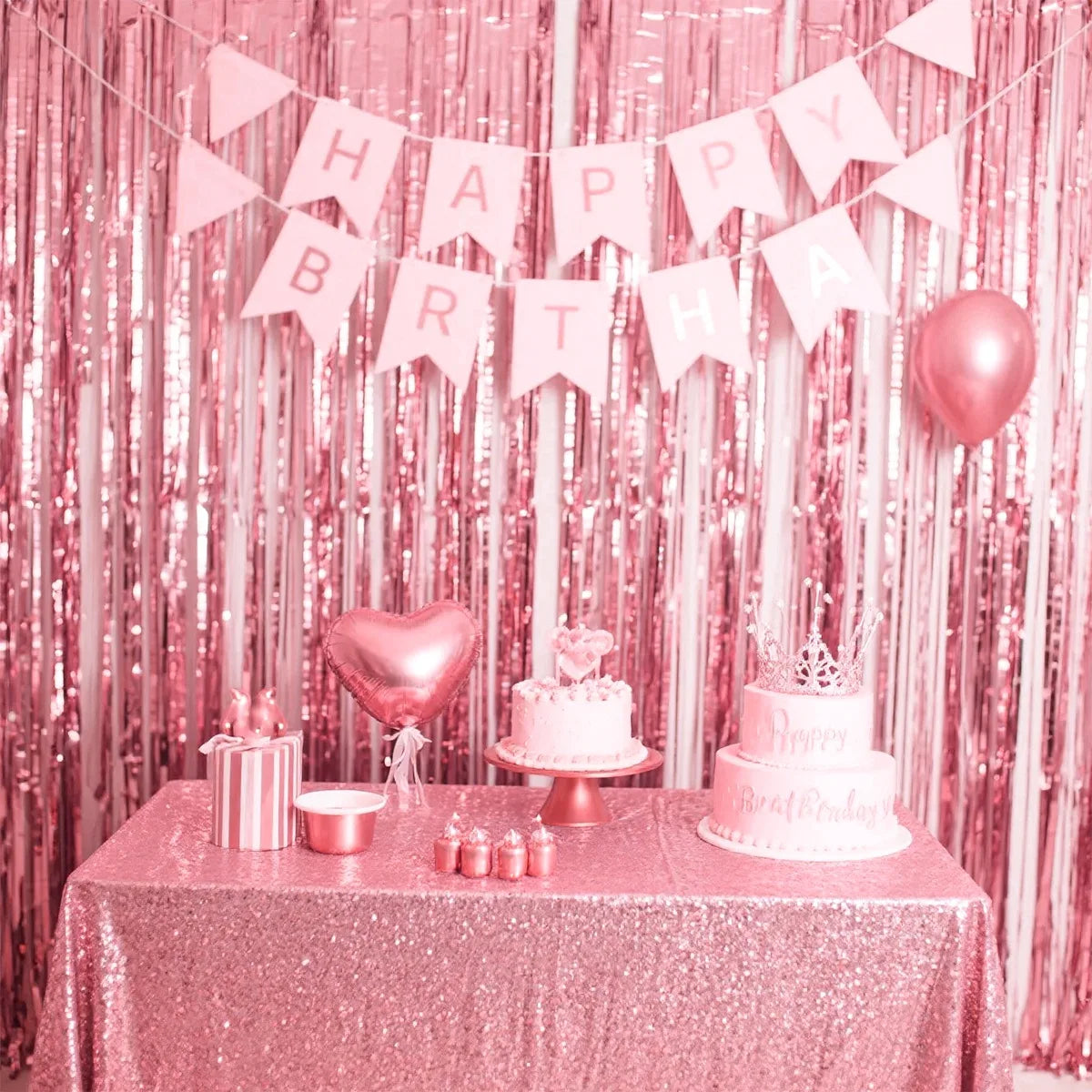 A pink sequin glitter party backdrop featuring a banner and a tiered cake on a table.