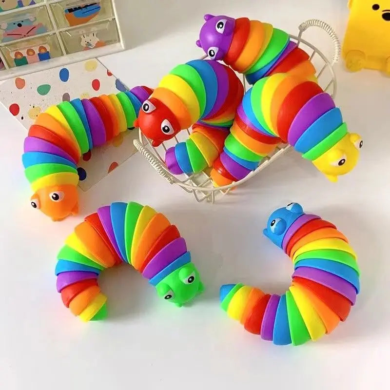 A collection of colorful, flexible, striped fidget slug toys in various shades of orange, yellow, green, blue, and purple.