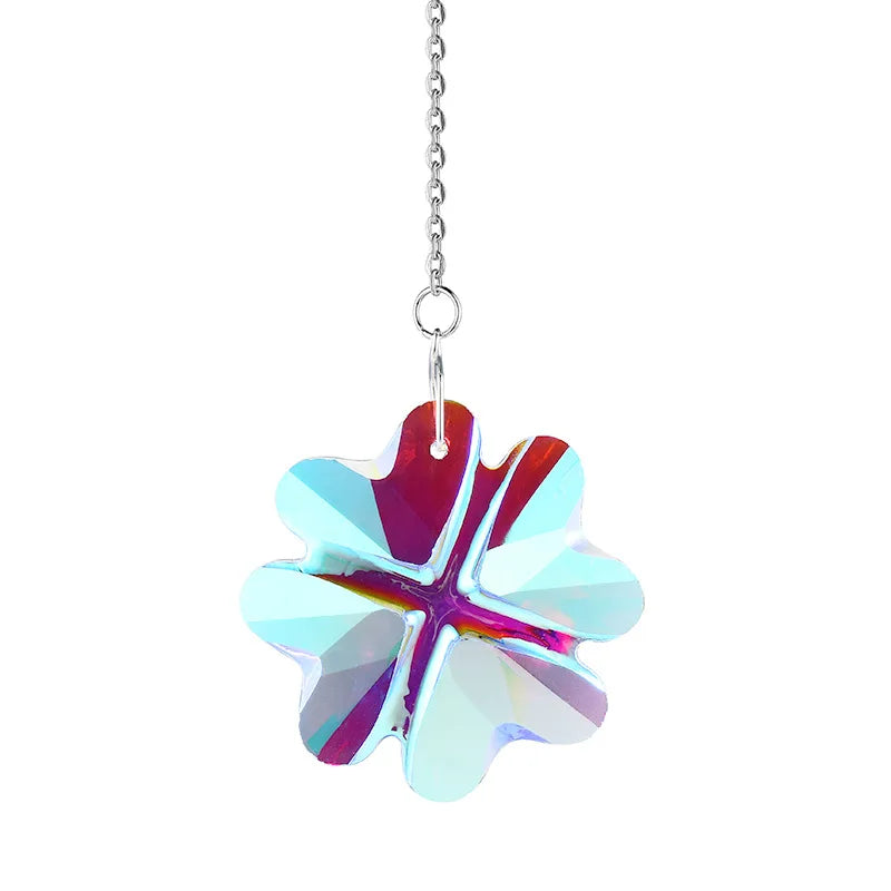 A clear, faceted crystal flower wind chime hanging from a silver chain.