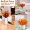 Artificial plants featuring vibrant orange and red foliage used for autumn home decor